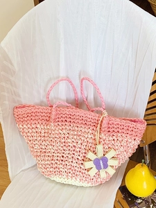 Summer woven straw tote bag with pink gradient stripes and a decorative flower charm