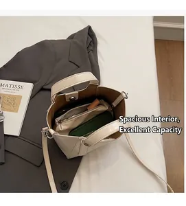 Detailed view of the cream bucket bag interior showing a matching zippered pouch