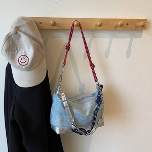Detail of light blue glitter tote with tricolor braided rope strap and metal chain