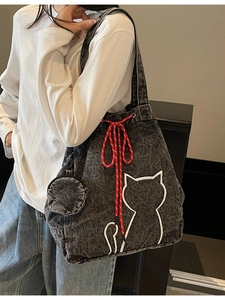 Large washed denim tote bag with white cat embroidery and red drawstring for casual use