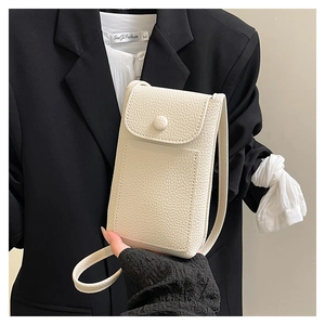 Detail of cream lychee texture crossbody phone bag with magnetic flap closure