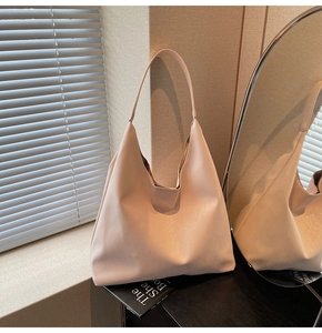 Detail of light pink large hobo bag showing vertical texture and single handle design