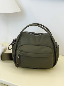 Olive green nylon crossbody bag with adjustable wide strap and silver metal hardware