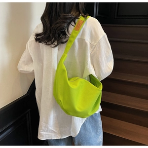 Neon green hobo bag featuring a detailed brown leather patch on the shoulder strap