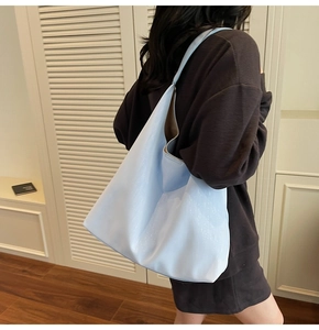 Detail of light blue mirror finish tote bag showing sleek hobo style and large capacity