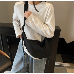 Black canvas crescent bag with Ziyouse label shown as a stylish crossbody on a model