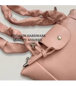 Close-up of pink pleated handle and high-quality silver hardware on a women handbag