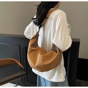 Detail of earthy tone canvas crescent crossbody bag with matching wide shoulder strap