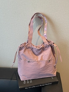 Fashionable mauve nylon tote bag with drawstring closure and metallic shoulder straps