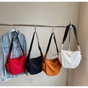 Multiple colors of large nylon dumpling bags hanging on racks for storage display