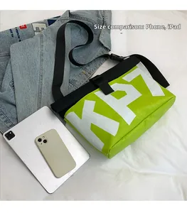 Detail showing high-capacity messenger bag holding an iPad and phone for size reference