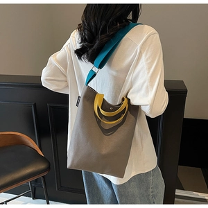 Détail des couleurs contrastées sur le sac cabas en toile grise avec bandoulière bleue
