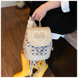 Detailed view of cream PU leather backpack with lace trim, bows and silver chain strap