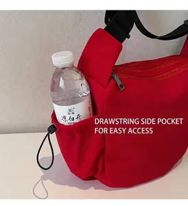 Detail of red canvas bag side pocket with adjustable drawstring for water bottles