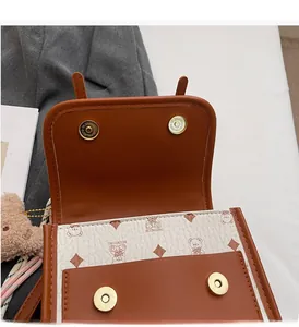 Detail of vintage tote bag showing strong magnetic snaps and cartoon bear pattern