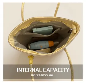 Interior view of yellow bucket bag with zipper pocket containing daily essentials