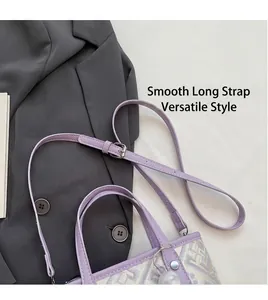 Detail of lavender bucket bag with geometric jacquard pattern and marble bead charm