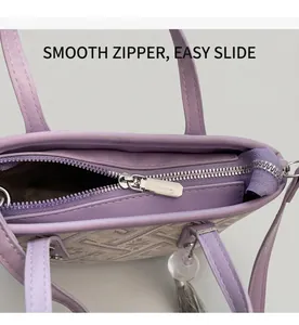 Close-up of smooth metal zipper and geometric woven fabric on a purple bucket bag