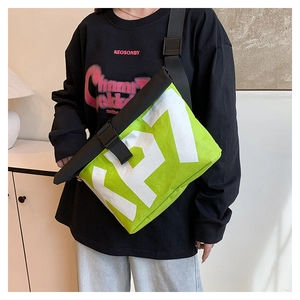 Close-up of neon green messenger bag with KP7 lettering and black buckle closure