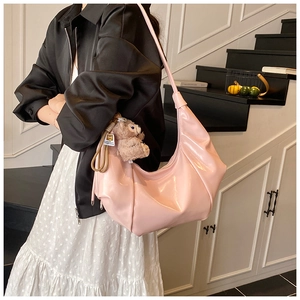 Close-up of pink glossy pleated shoulder bag featuring a stylish ShellieMay plush charm