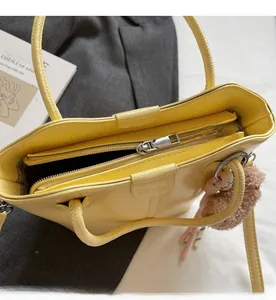 Detailed interior of the yellow leather bucket bag showing smooth zipper and compartments