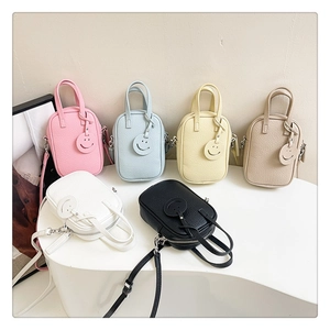 Detailed view of mini litchi grain purses in six pastel colors with smiley pendants