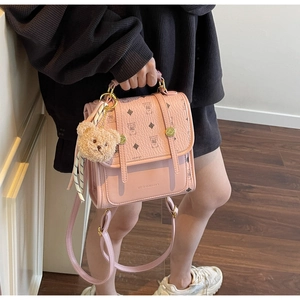 Detail of pink faux leather backpack with vintage bear print and golden metal buckle