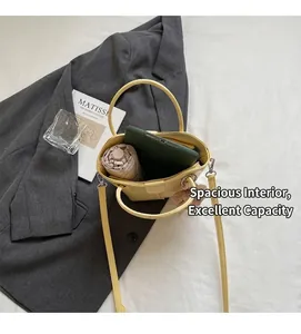 Spacious interior of yellow bucket bag holding a tablet and folding umbrella