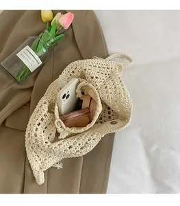 Close-up of handmade crochet tote bag featuring intricate openwork and drawstring lining