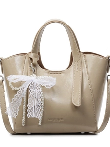 Elegant cream bucket bag with lace bow and pearl charm for casual crossbody wear