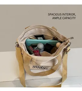 Internal view of beige canvas tote showing spacious capacity for tablet and daily items