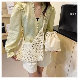 Detail of cream crochet tote bag with woven texture, tassel straps and inner pouch
