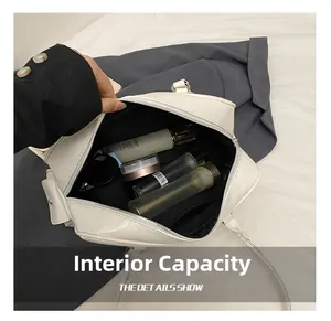 Macro shot of large internal capacity showing spacious interior and silver zipper of white bag