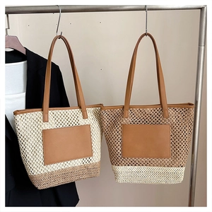 Detailed close-up of handmade woven straw tote bags with leather straps and patch details