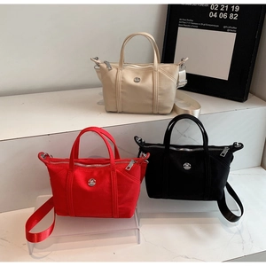 Nylon crossbody bags in beige, red, and black with M logo and adjustable straps