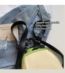 Detail of lightweight waterproof crossbody bag featuring green and beige color-block design