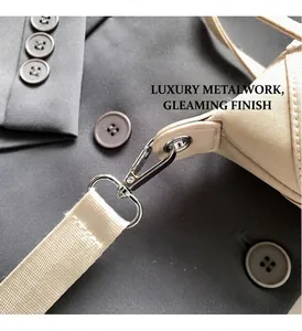 Detail of a beige canvas bag showing polished silver metal hardware and nylon strap