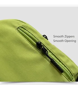 Detail of smooth black zipper and tear-resistant neon green fabric on waterproof bag