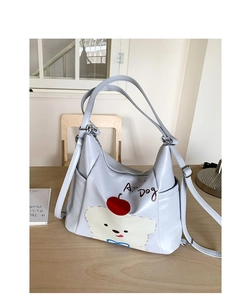Détail du sac cabas gris clair avec motif de chien mignon et imprimé cerise rouge