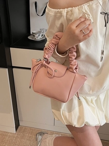 Fashionable pink pleated handbag with bow detail and cloud handle for women