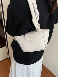 Minimalist beige ruched shoulder bag for women with scrunched strap and silver metal clasp