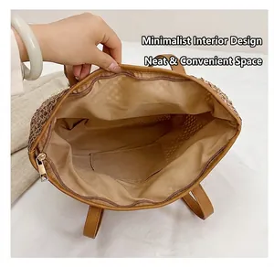 Detailed interior of straw tote bag showing brown fabric lining and zipper pocket