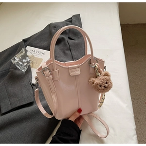 Pink patent leather bucket bag with teddy charm, silk ribbon and adjustable shoulder strap