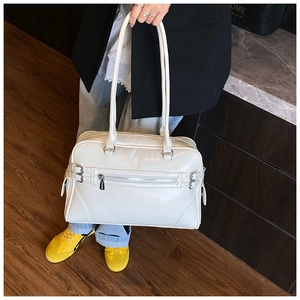 White glossy PU leather tote bag with long shoulder straps and front zipper pocket detail