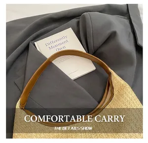Detail of hand-woven straw tote bag with premium brown leather handle and fine stitching