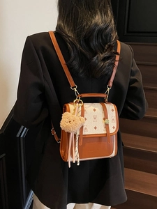 Retro brown and cream patterned backpack with teddy bear charm and ribbon decor