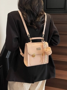 Minimalist light pink leather commuter backpack with gold buckles and cute bear charm