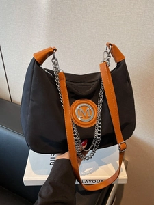 Black and orange crossbody hobo bag with silver chain and metal M logo detail