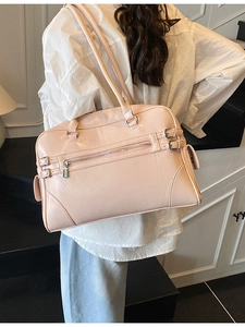 Pink minimalist Boston shoulder bag with adjustable decorative buckles and zip pocket