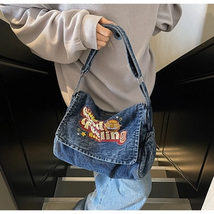 Detail of vintage denim tote bag with Feel Good embroidery and adjustable wide strap